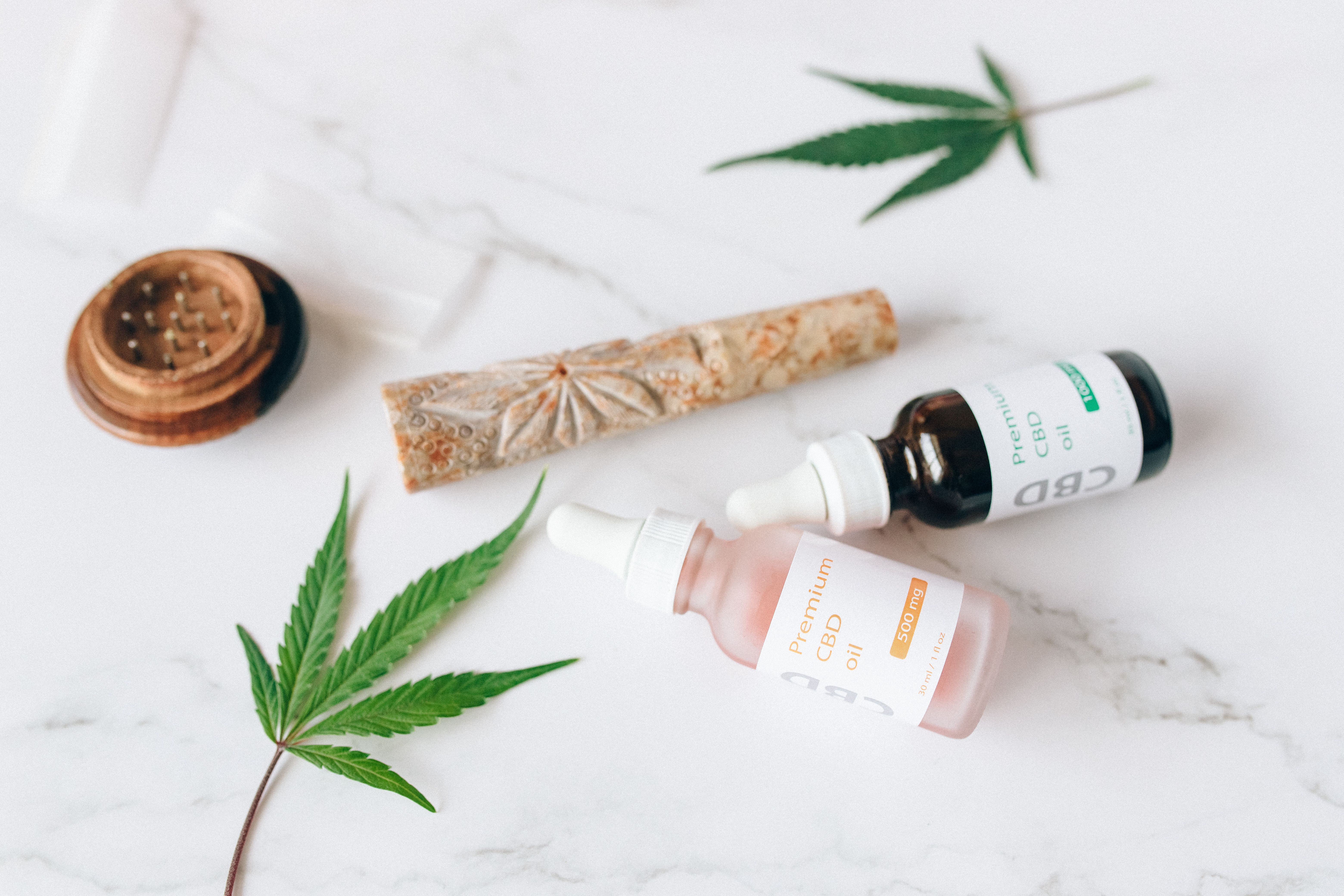 Premium CBD oil bottles with hemp leaves