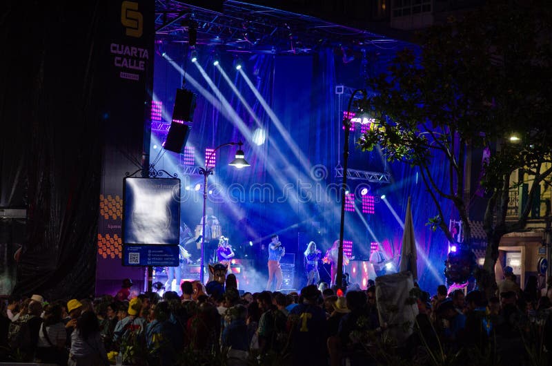 Outdoor concert festival with colorful lights